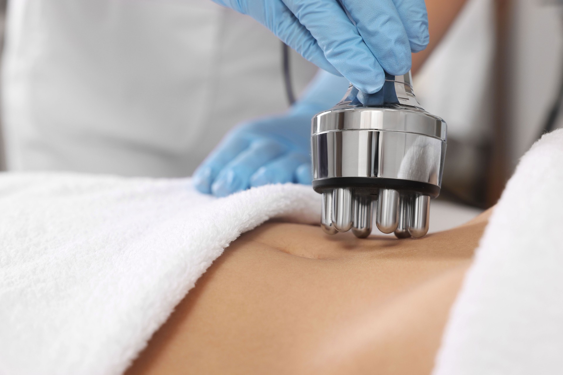 Woman undergoing radio frequency lifting procedure in beauty salon, closeup